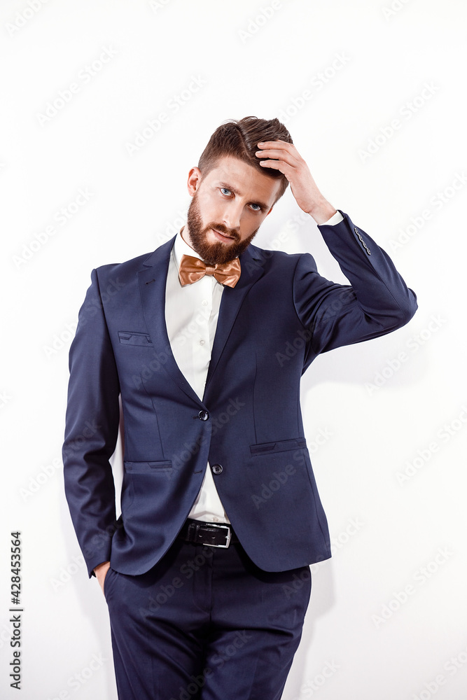 Elegant young handsome man in black classic costume. Studio fashion portrait. Elegant young handsome man in black classic costume. Studio fashion portrait.