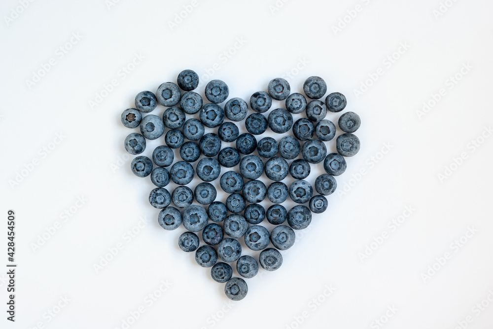 Frozen bluberries in shape of heart, healthy food concept