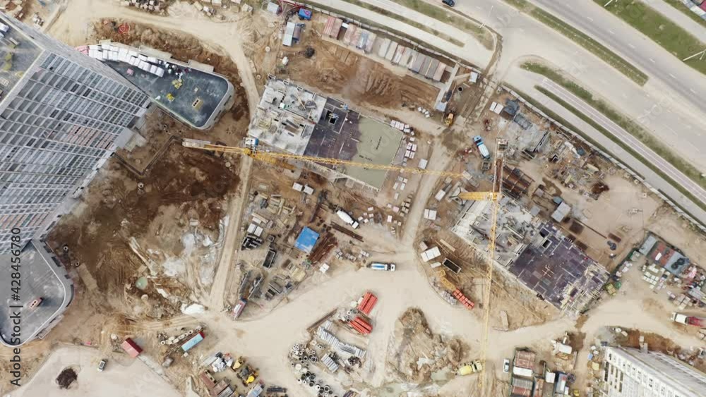 Aerial top down view construction with yellow tower cranes working on ...