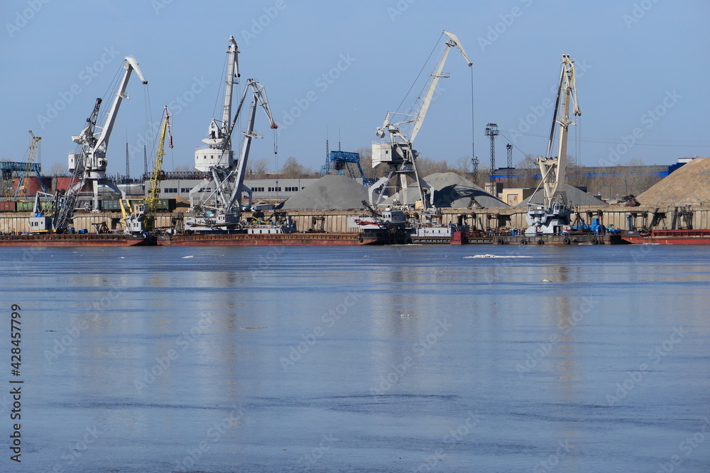 View of a large river and river port with special equipment and water transport. High quality photo