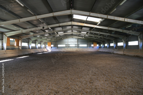 Photo of an empty indoor riding hall for horses and riders