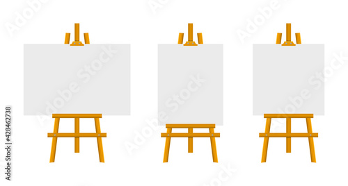Empty canvas on wooden easel. Wooden brown easels. Blank art board. Mock up white canvas for painting. Easels with horizontal, vertical and square paper posters. Space for your text and design.
