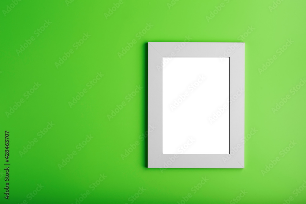 White photo frame on green background with free space. White photo frame on green background with free space.