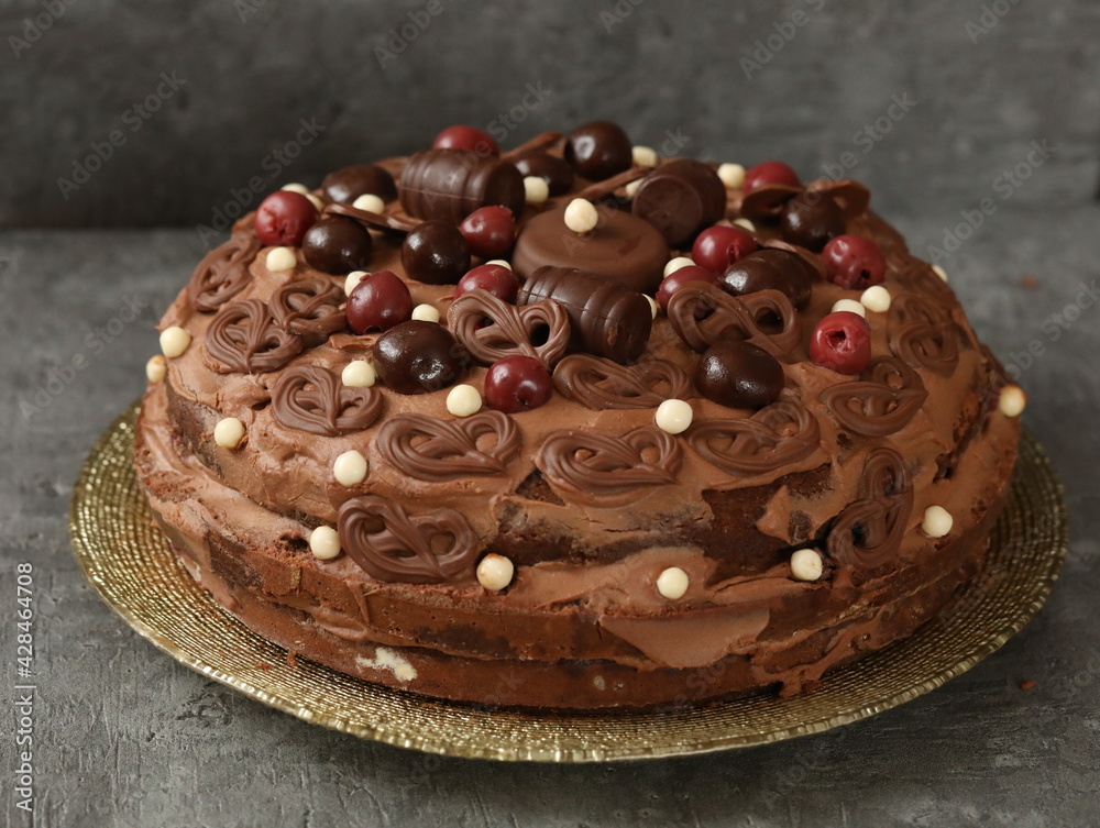 Birthday chocolate cake decorated with chocolates and cherries Birthday chocolate cake decorated with chocolates and cherries