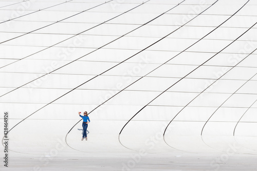 Young woman taking selfie photo on smartphone near Heydar Aliyev Center in Baku, Azerbaijan. photo