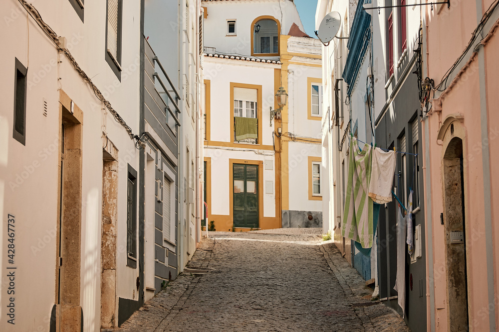 Narrow streets with old buildings and laundry hanging in Algarve, Portugal Stock Photo Adobe Stock