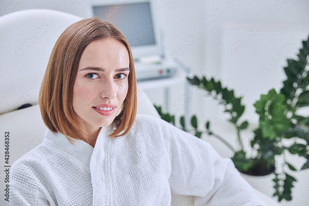 Elegant redheaded female resting in beauty clinic Elegant redheaded female resting in beauty clinic