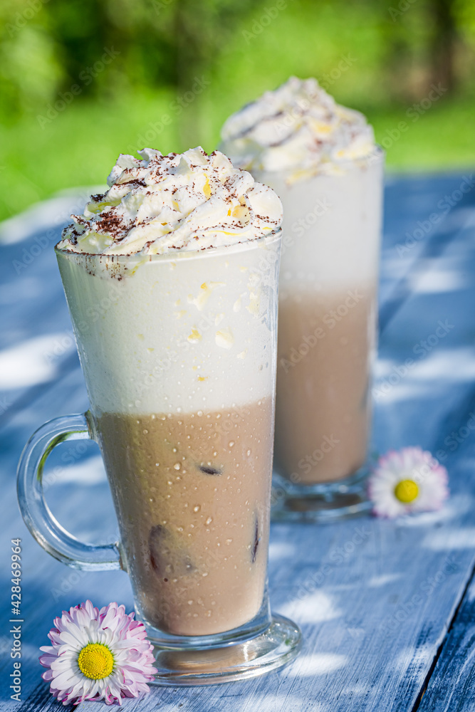 Sweet latte with ice and cream. Coffee in garden.