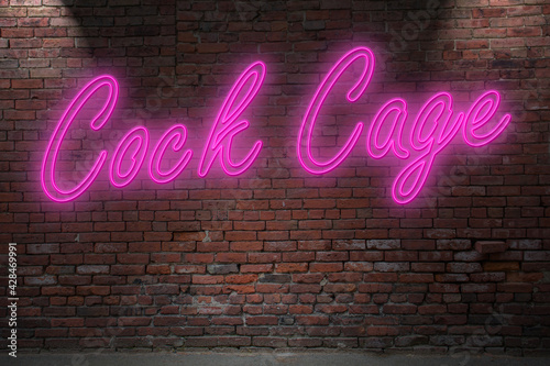 Neon Cock Cage lettering on Brick Wall at night