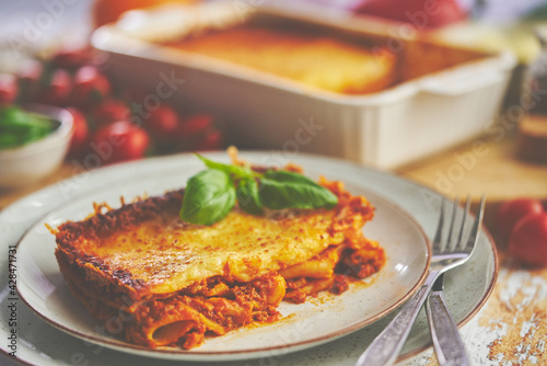 Tasty traditional italian lasagna with bolognese, melted and cheese. Served with ingredients