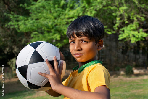 Young boy holding soccer ball 