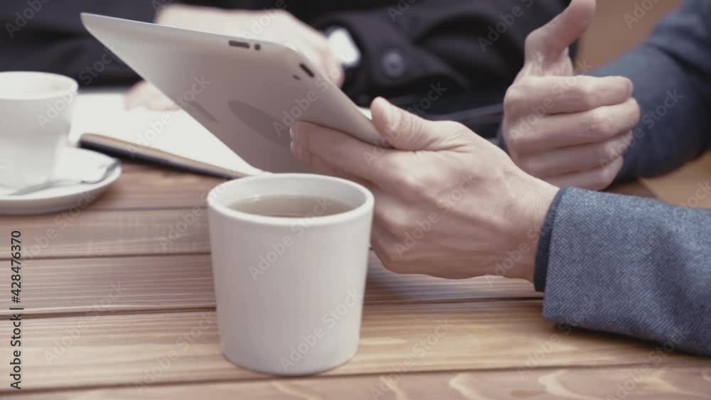 Caucasian male using tablet on the street Caucasian male using tablet on the street