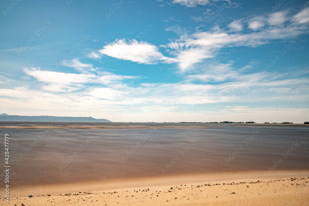 Sand, clouds and lake with blue sky Sand, clouds and lake with blue sky