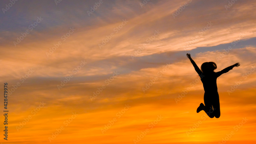 Jumping Woman At Sunset, Silhouettes, Freedom And Happiness Jumping Woman At Sunset, Silhouettes, Freedom And Happiness