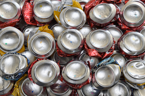 Bottom view of crushed aluminum cans for beer and cider beverages ready for recycling