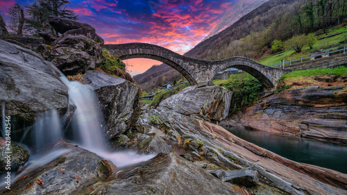 A double arch stone bridge at Ponte dei Salti over the clear water of the Verzasca River. Travel Switzerland near  Lavertezzo, Ticino. photo