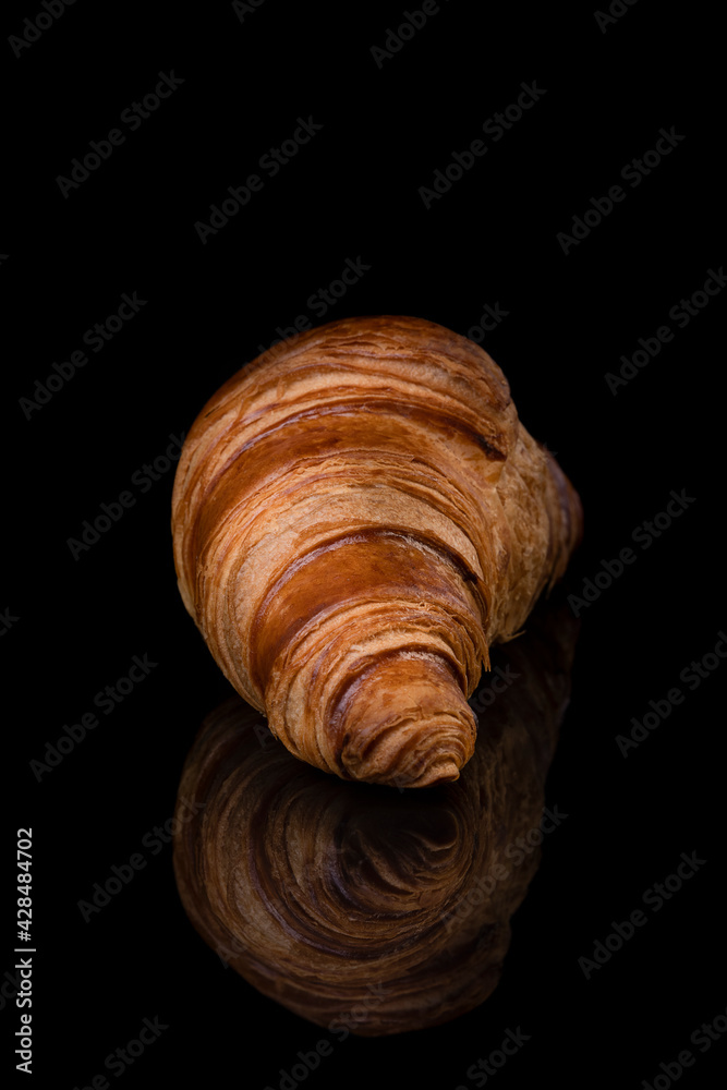 Croissant on black reflective studio background. Isolated black shiny mirror mirrored background for every concept.. Croissant on black reflective studio background. Isolated black shiny mirror mirrored background for every concept..