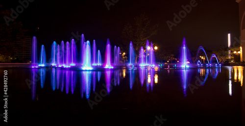 Long exposure of a colourful fountain at a mall in Merida, Mexico - located in their beautiful grounds outdoor and amusement park - purple lights