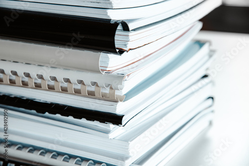 Φωτογραφία Stack of reports lies on a desk ready for review