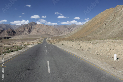 Road at the foot of a bare mountain in Ladakh, India