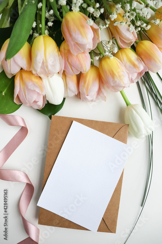 postcard layout. bouquet of tulips on white background and space for text 