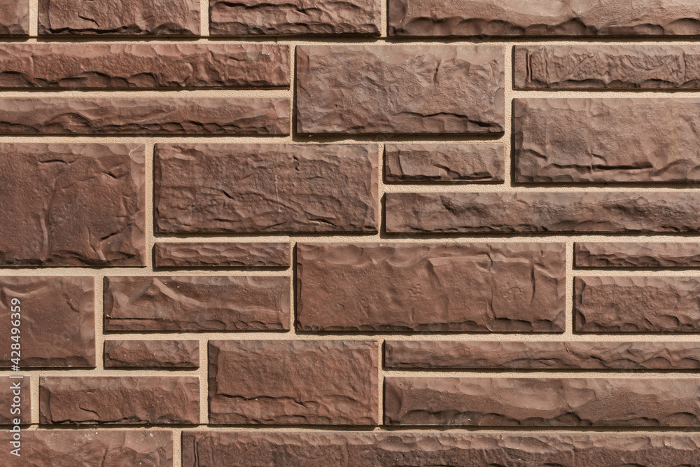 Obraz premium Surface with brown tiles with a stone texture for the exterior.