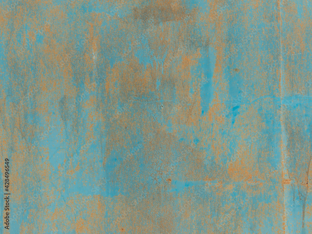The metal surface is worn with rust and peeling blue paint