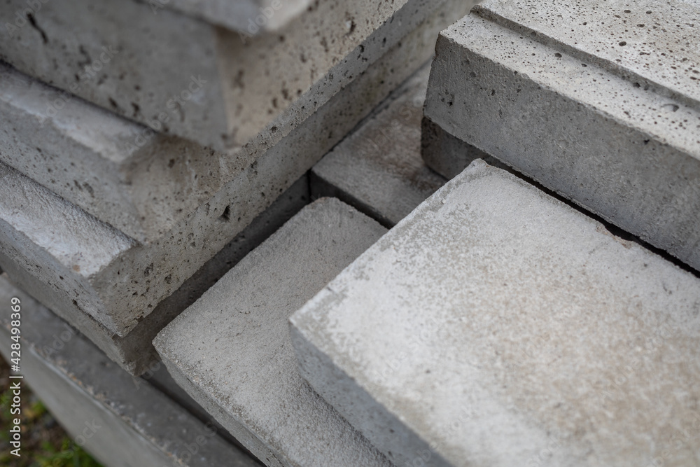 Selective focus, stack of concrete blocks. Building material cement cube bricks.