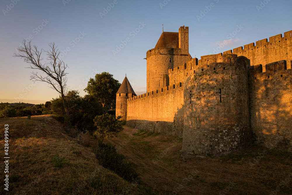 Dawn light illuminates the exterior of the castle walls and fortified city of Carcassonne, UNESCO World Heritage Site, France