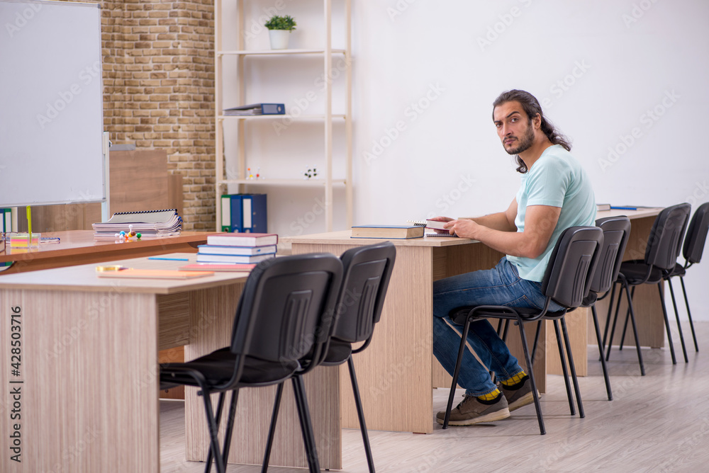 Young male student in the classroom during pandemic Young male student in the classroom during pandemic