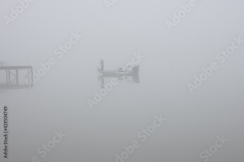 Single Fisherman in Early Morning Fog