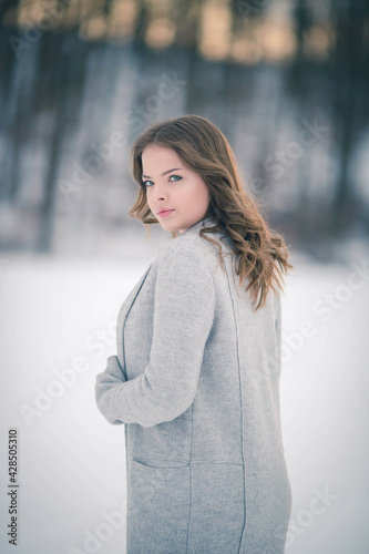 Fashionable Bosnian Caucasian woman looking at the camera with a serious face photo