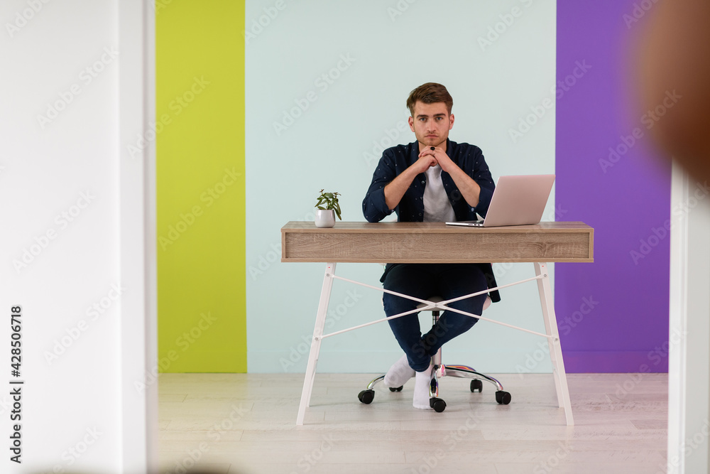 Smiling young man freelancer using laptop studying online working from home Smiling young man freelancer using laptop studying online working from home