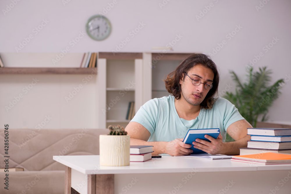 Young male student preparing for exams at home Young male student preparing for exams at home