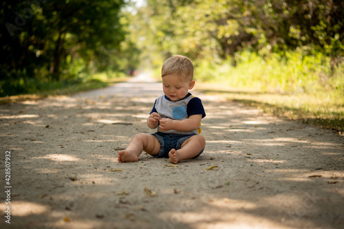 child sitting on path