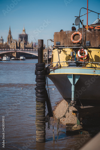 Tamesis Dock, brightly painted barge floating on the Thames, with views of Parliament, outdoor space and a bar. photo