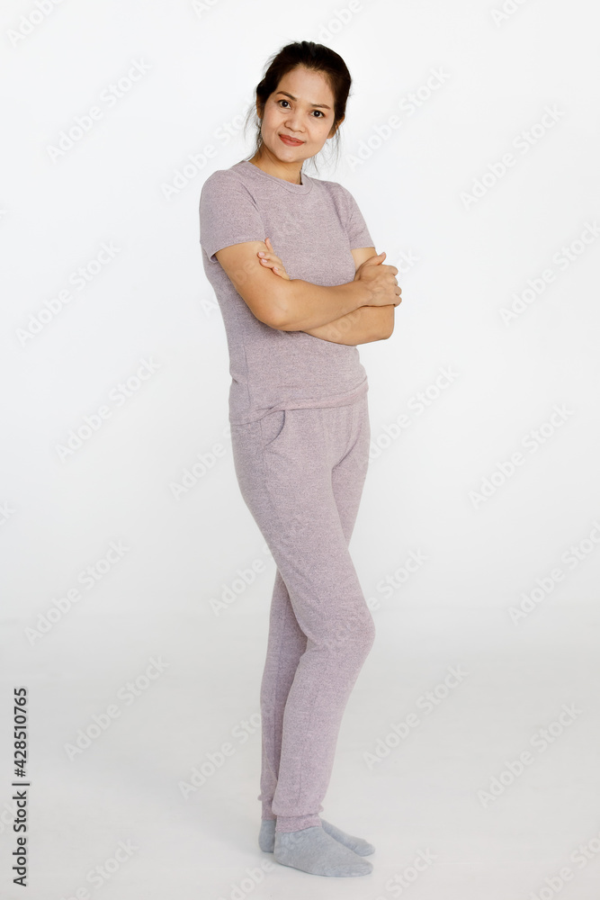 Portrait shot of Asian middle aged happy healthy beautiful long hair senior retirement female housewife wears pink gray cloth stand alone look at camera hands cross on chest on white background Portrait shot of Asian middle aged happy healthy beautiful long hair senior retirement female housewife wears pink gray cloth stand alone look at camera hands cross on chest on white background