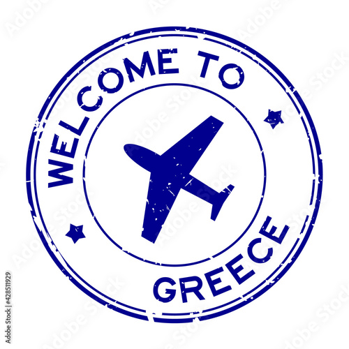 Grunge blue welcome to Greece word with airplane icon round rubber seal stamp on white background