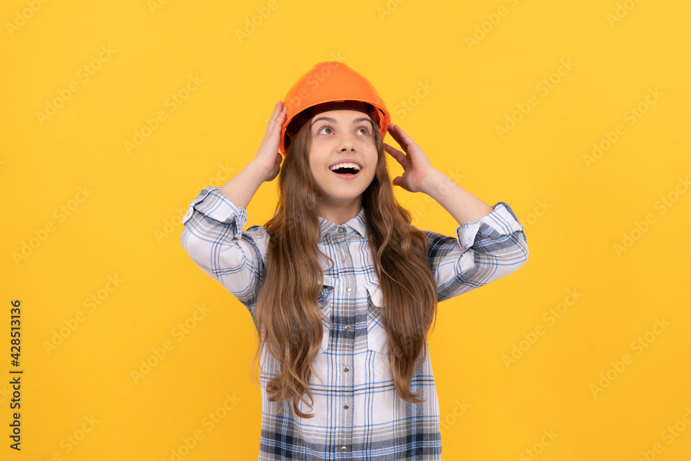 happy teen girl in helmet and checkered shirt, architect