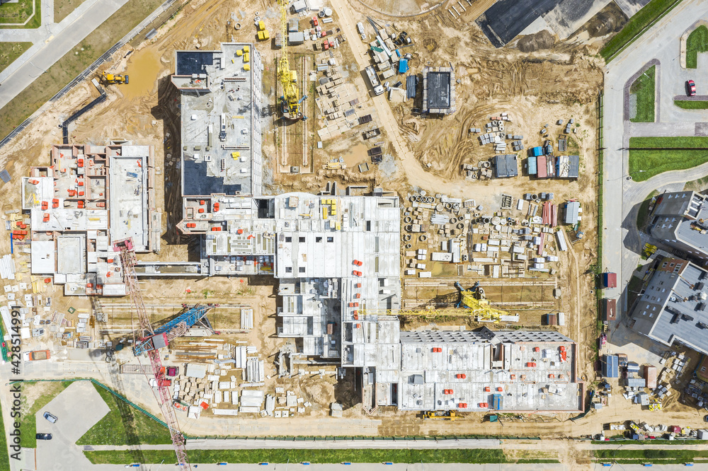 new construction site with cranes and building materials. aerial photo, top view new construction site with cranes and building materials. aerial photo, top view