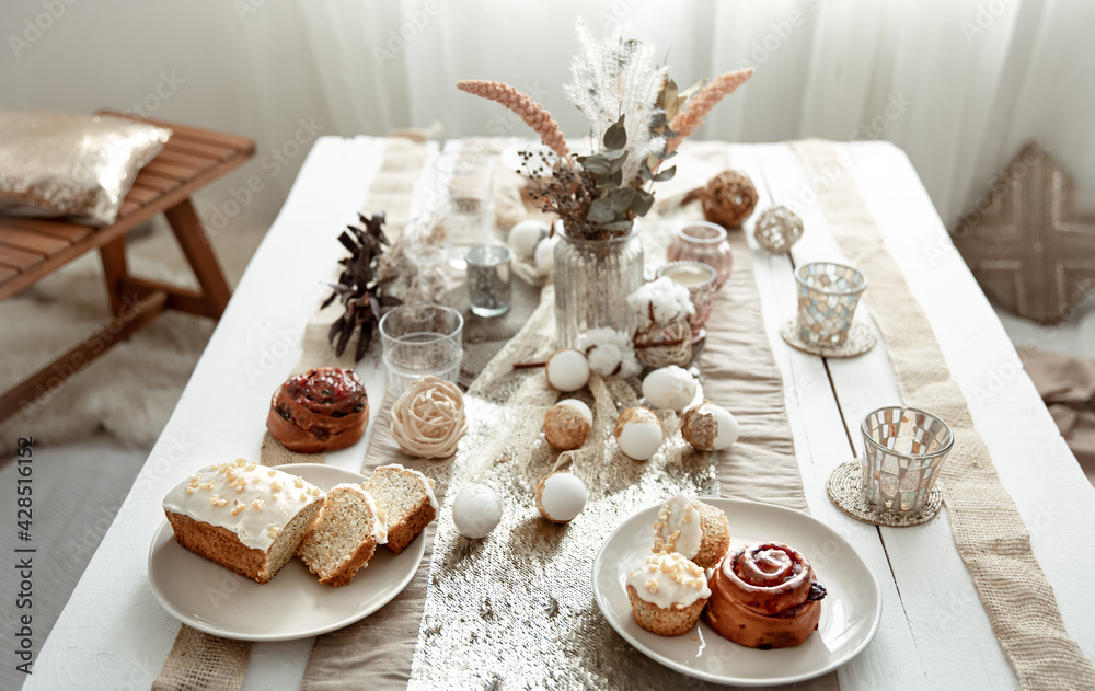 Fototapeta premium Festive table for Easter with decor details and homemade cakes.