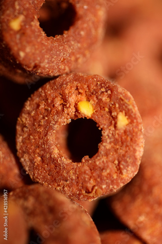 A top view shot of a manufactured dry dog round with hole croquette food modern background high quality big size print Dog dry healthy food from purina close up background high quality big size prints