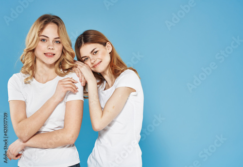 Cute women hug Friendship emotions blue background