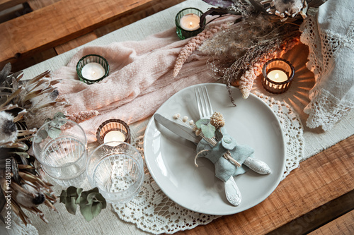Festive table setting in vintage style with dry flowers close up.