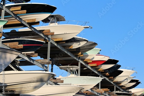 Row of boats sticking out of a boat storage rack in a marina. Maritime storage boat yard