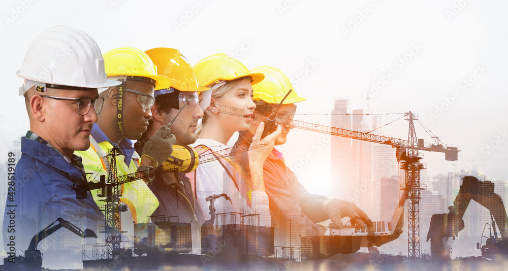 Group of architects and engineers at a building site , Team of expert architects on construciton site in helmets checking workflow