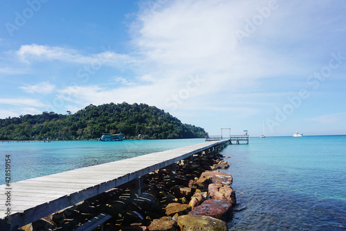 Summer landscape on tropical koh Kood island in Thailand. Landscape with long wooden pier taken on Bang Bao beach.