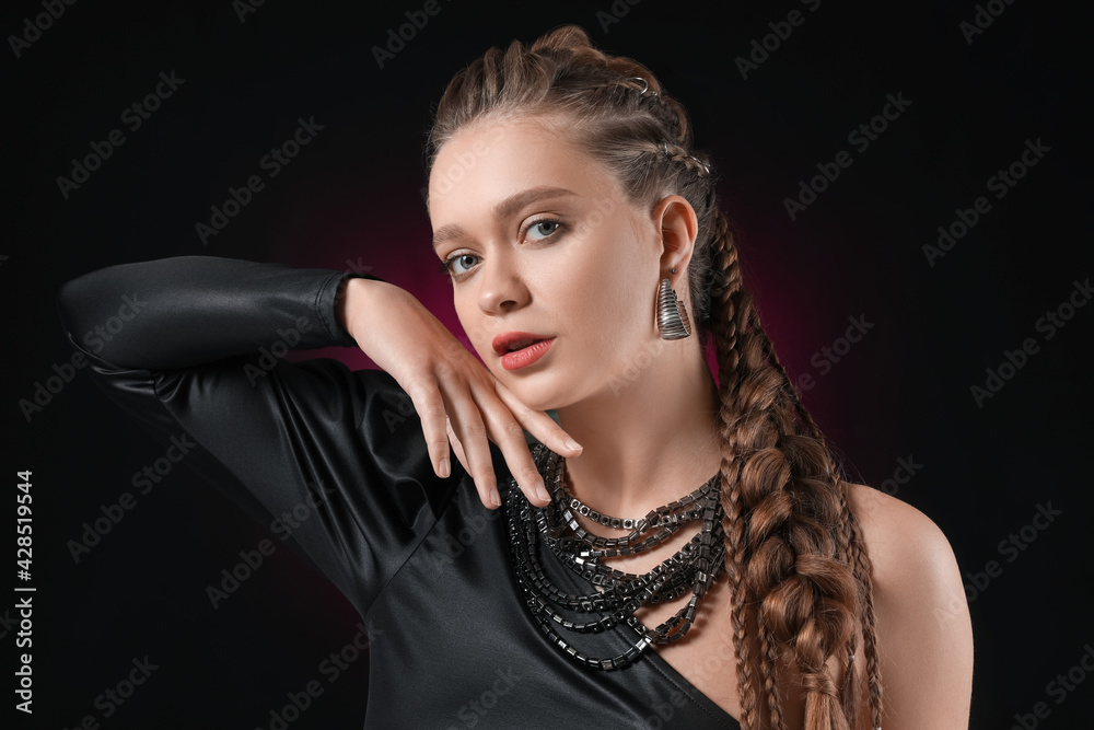 Beautiful young woman with braided hair on dark background Beautiful young woman with braided hair on dark background