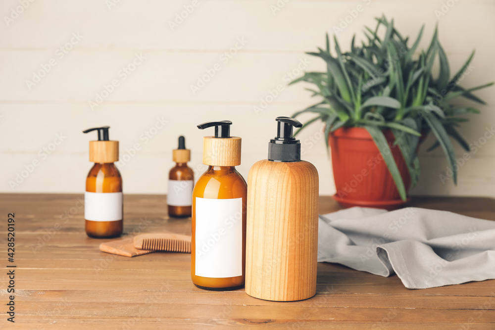 Bottles with natural shampoo on wooden background Bottles with natural shampoo on wooden background