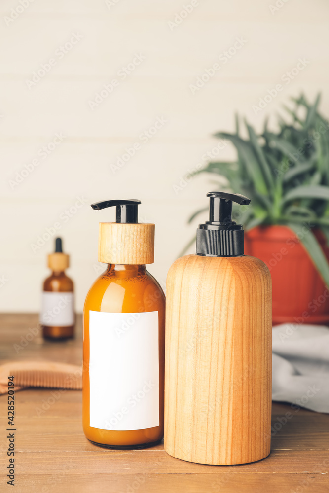 Bottles with natural shampoo on wooden background Bottles with natural shampoo on wooden background